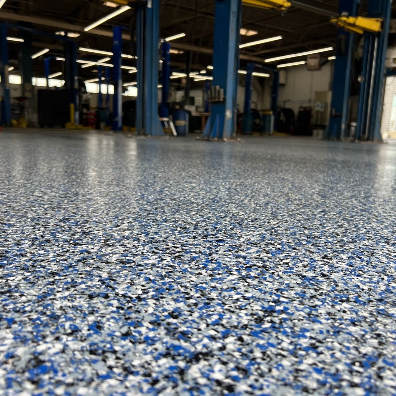 Blue full flake polyaspartic auto shop floor coating β Shipp-Mates Epoxy of the Ozarks